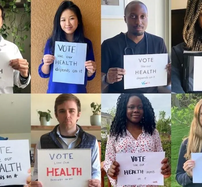 People holding signs that say 