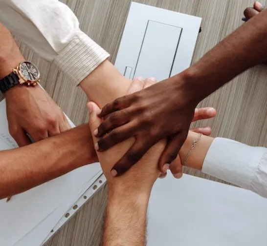 People's hands in a circle
